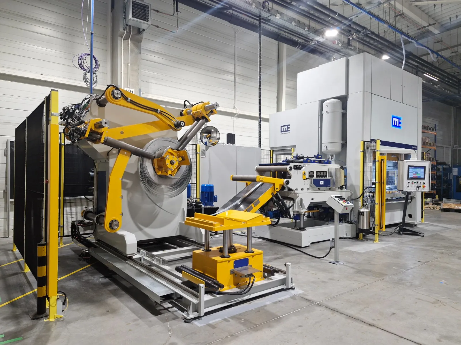Mecânica Exacta complete coil-feeding and stamping line — decoiler, straightener, feeder and press